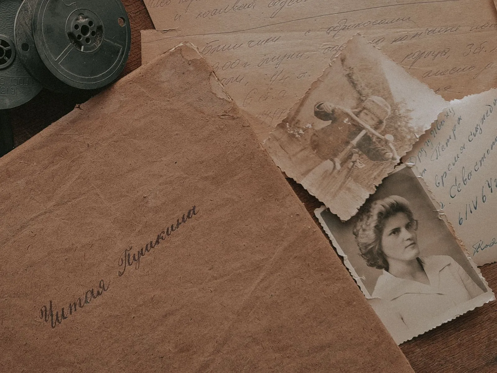 A nostalgic still life of vintage photographs, handwritten letters, and film reels, evoking a sense of the past.